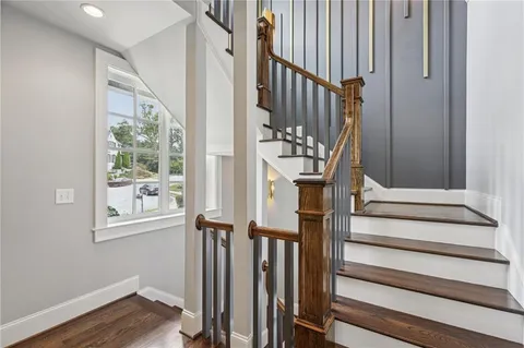 a bathroom with a granite countertop sink a toilet and a mirror