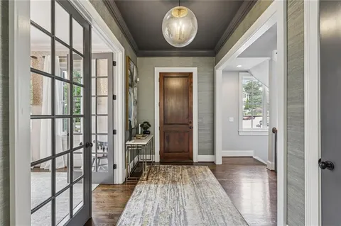 a living room with furniture a fireplace and a chandelier