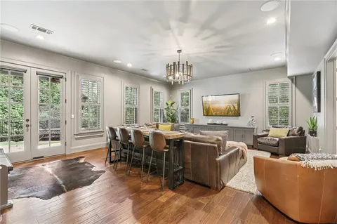 a kitchen with stainless steel appliances granite countertop a stove a sink dishwasher a refrigerator white cabinets with wooden floor