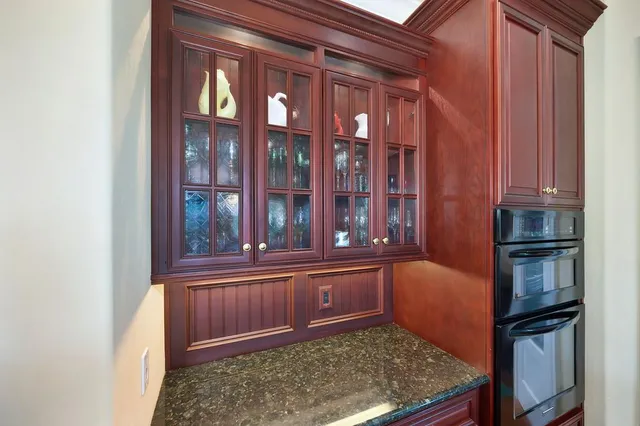 a living room filled with furniture potted plant and a large window