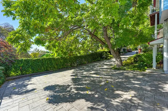 a backyard of a house with lots of green space and a fountain