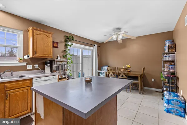 a kitchen with a table chairs and microwave