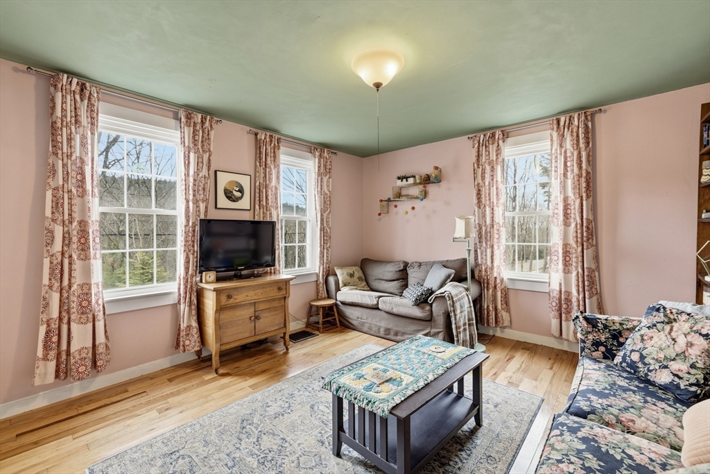 118 North Leverett Road Leverett, MA 01054 - Photo 6 of 26 a living room with furniture a flat screen tv and a large window