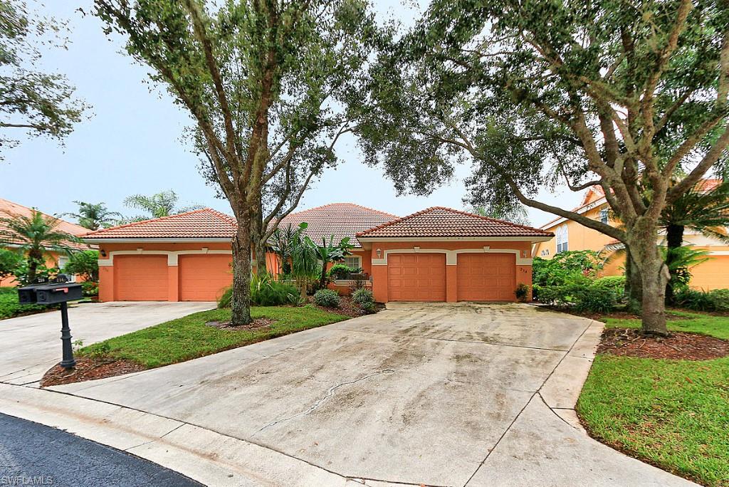 214 Napa Ridge Road East Naples, FL 34119 - Photo 12 of 12 a front view of a house with a yard and garage