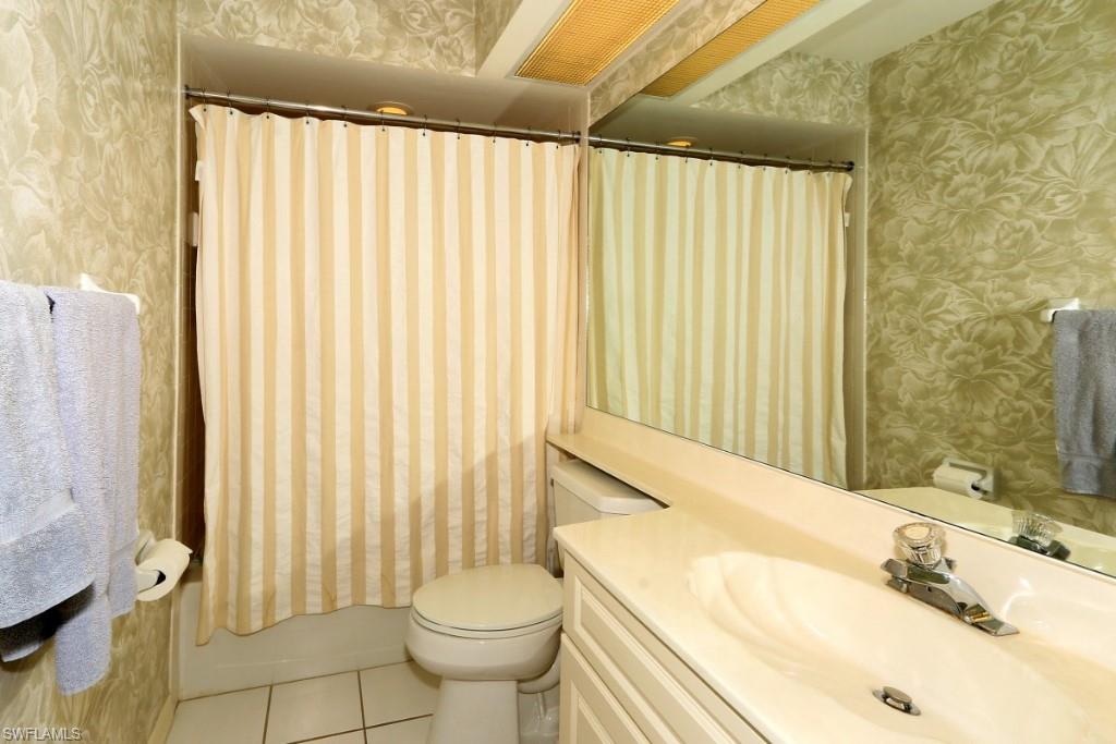 214 Napa Ridge Road East Naples, FL 34119 - Photo 8 of 12 a bathroom with a sink a toilet and tub