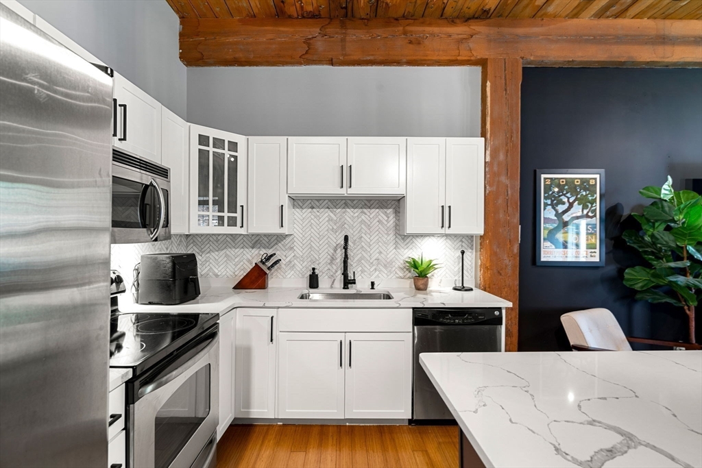 1511 Main Street, Unit B101 Worcester, MA 01603 - Photo 2 of 41 a kitchen with a sink a stove and cabinets