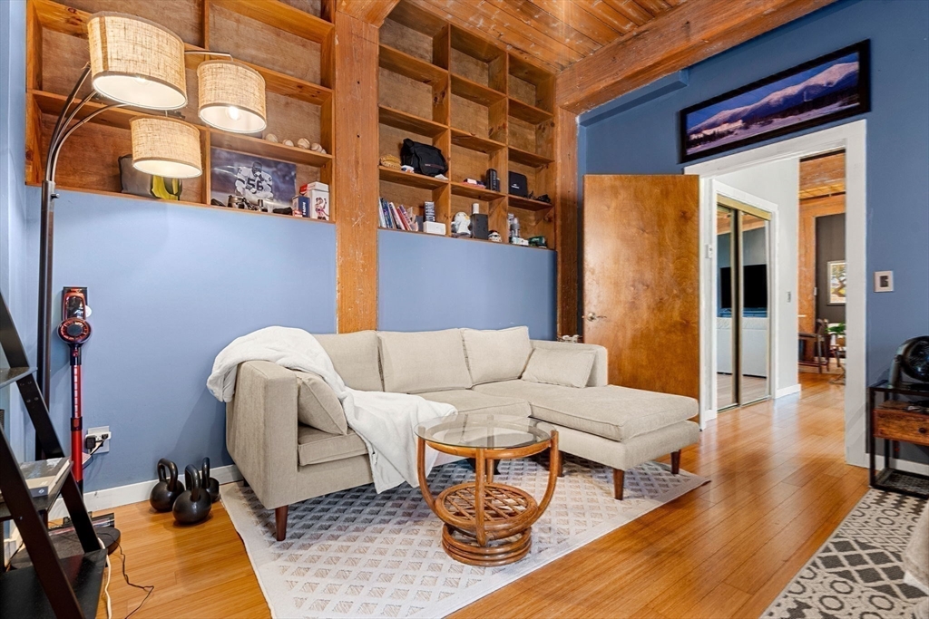 1511 Main Street, Unit B101 Worcester, MA 01603 - Photo 21 of 41 a living room with furniture and a rug