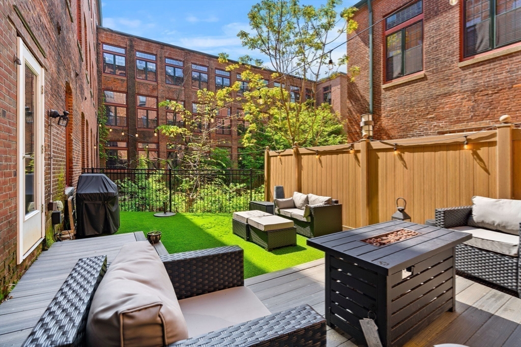 1511 Main Street, Unit B101 Worcester, MA 01603 - Photo 26 of 41 a view of a patio with table and chairs and potted plants