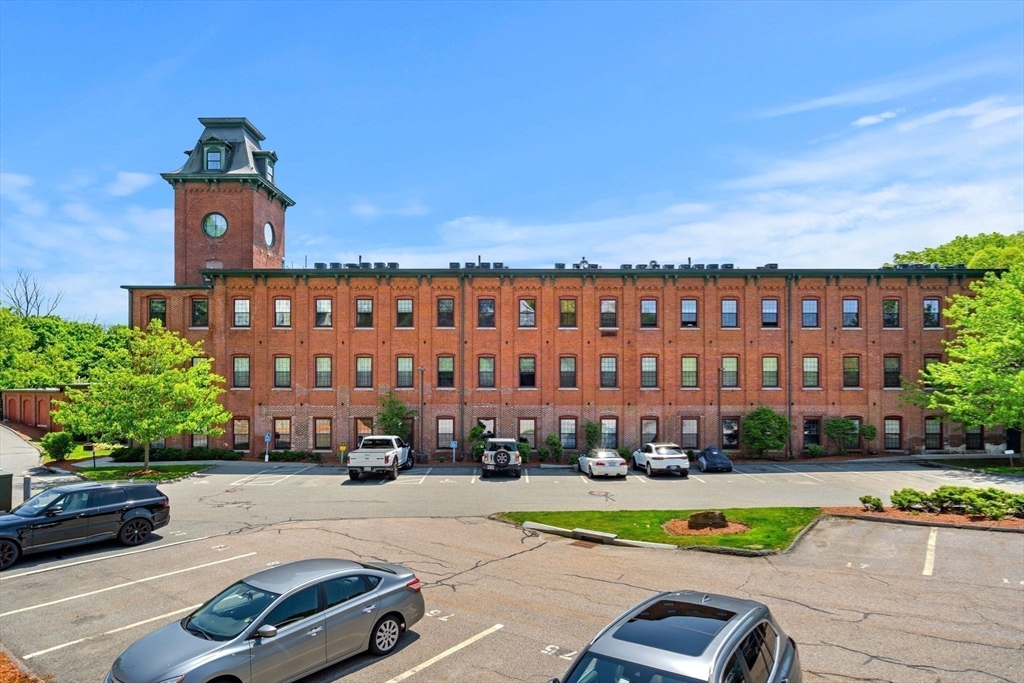 1511 Main Street, Unit B101 Worcester, MA 01603 - Photo 35 of 41 a building view with a garden space and car parked