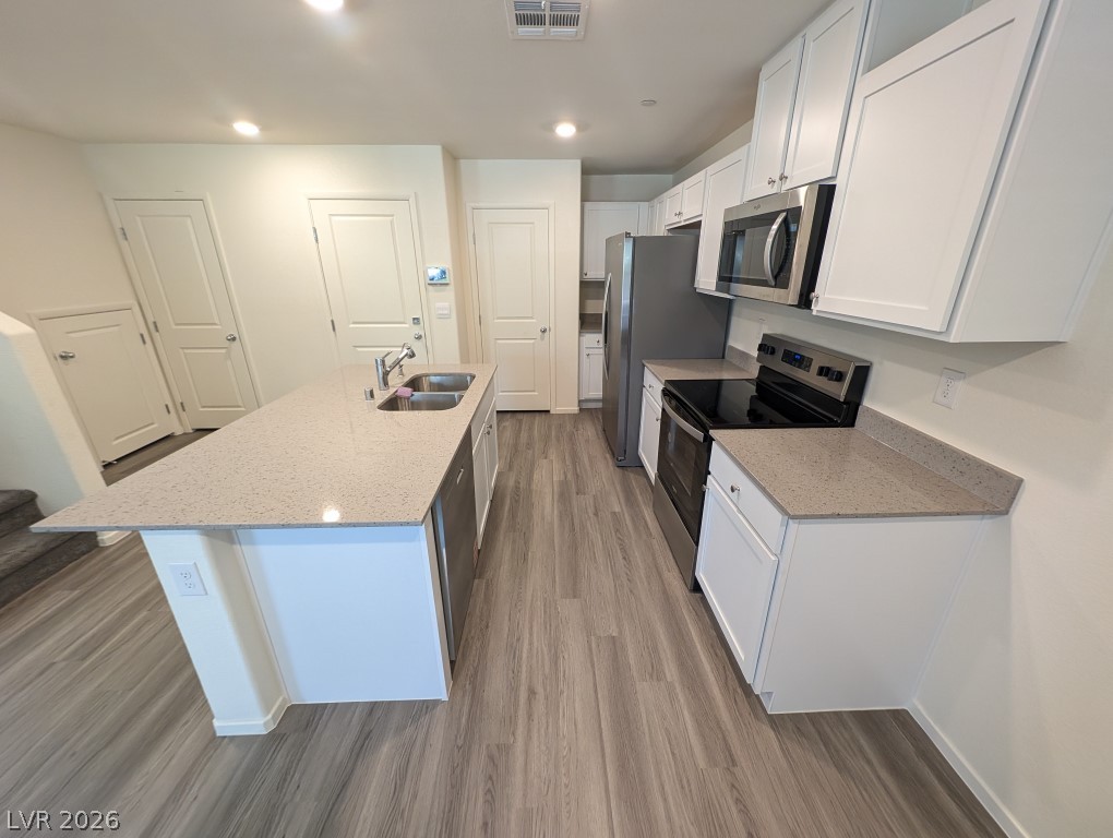 4820 Orchid Rdg Avenue Las Vegas, NV 89141 - Photo 8 of 27 A well-lit kitchen features modern stainless steel appliances and ample counter space, ideal for culinary creations.