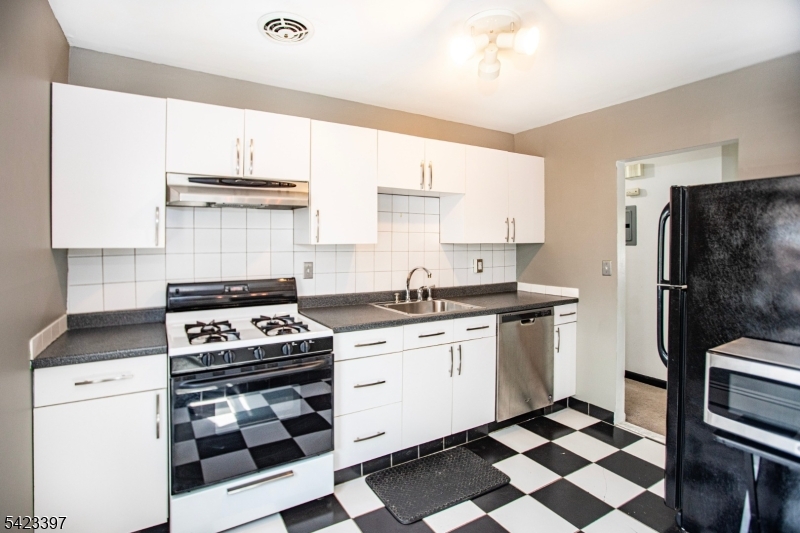 1130 Valley Road, Unit 2B Wayne, NJ 07470 - Photo 3 of 47 a kitchen with a stove a sink and a refrigerator