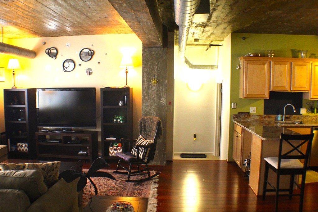 23-33 Middle Street, Unit 4 Lowell, MA 01852 - Photo 4 of 5 a living room with furniture and a flat screen tv