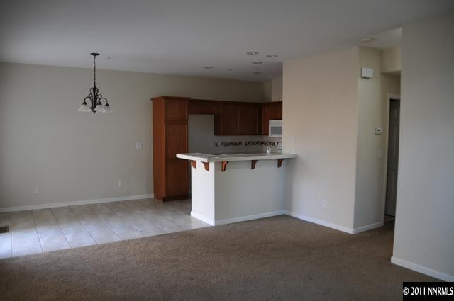 3871 Warren Way Reno, NV 89509 - Photo 4 of 13 a view of a kitchen with a sink cabinet and window