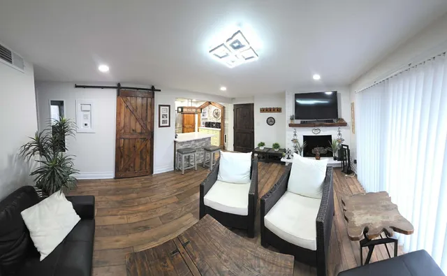 a living room with furniture and a flat screen tv