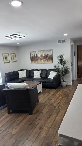 a living room with furniture and a potted plant