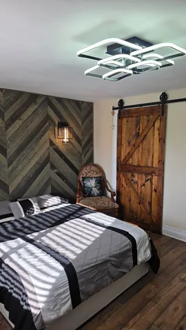 a bedroom with a bed and wooden floor