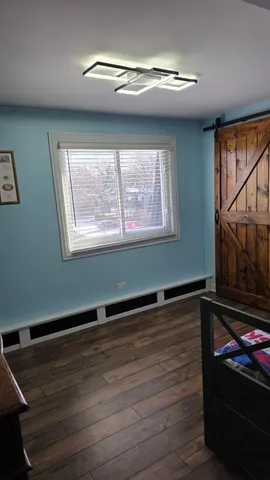 a room with wooden floor and window