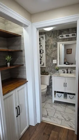 a bathroom with a sink a toilet and shower