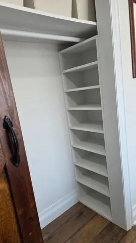 a view of walk in closet with empty racks