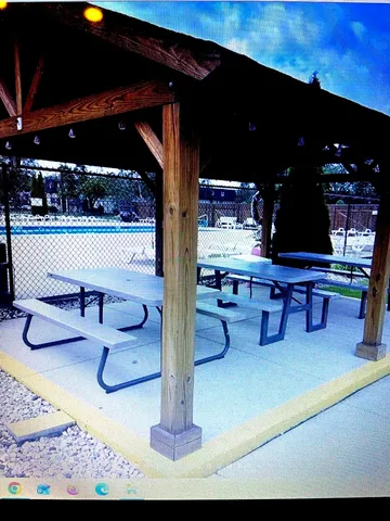 a view of a lobby with a dining table and chairs