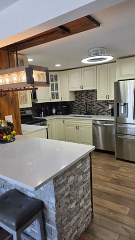 a kitchen with stainless steel appliances granite countertop a sink and a stove