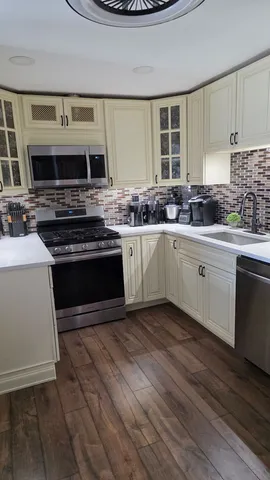 a kitchen with stainless steel appliances a stove sink and cabinets