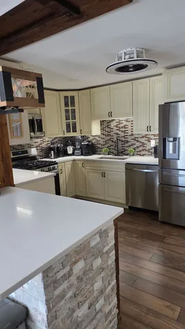 a kitchen with stainless steel appliances granite countertop a sink and a stove