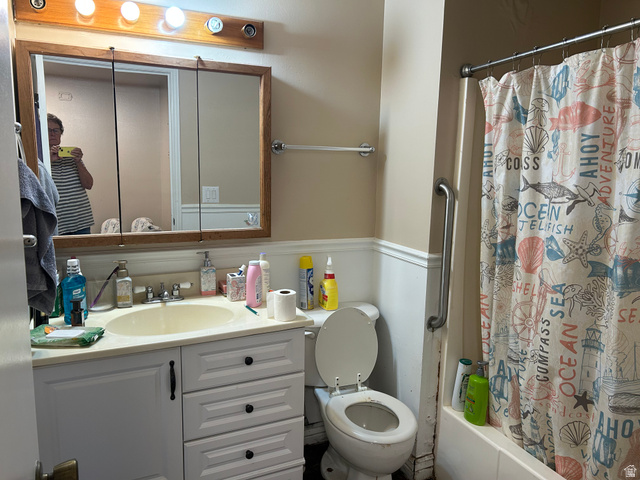 88 West 50 South, Unit C1 Centerville, UT 84014 - Photo 12 of 16 Bathroom featuring a white vanity with integrated sink, a framed medicine cabinet, and a built-in bathtub with shower
