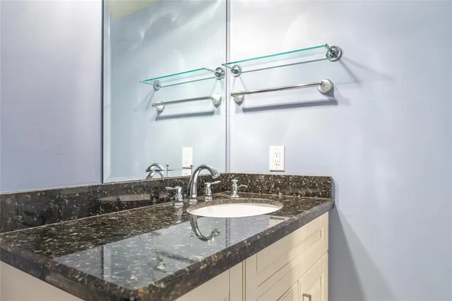 a bathroom with a glass shower door
