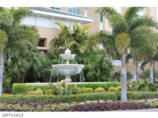 275 Indies Way, Unit 1603 Naples, FL 34110 - Photo 3 of 5 a view of a house with a yard and potted plants
