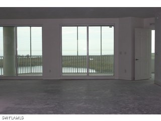 275 Indies Way, Unit 1603 Naples, FL 34110 - Photo 5 of 5 a view of an empty room with a window
