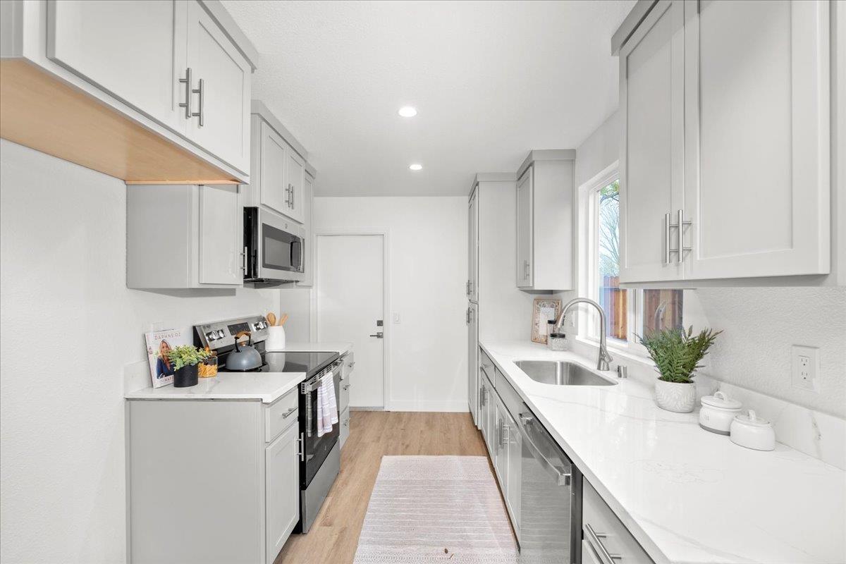 6637 Briartree Way Citrus Heights, CA 95621 - Photo 12 of 23 a kitchen with stainless steel appliances granite countertop a sink and dishwasher a stove top oven with white cabinets