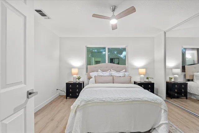 a bedroom with a bed and a large mirror