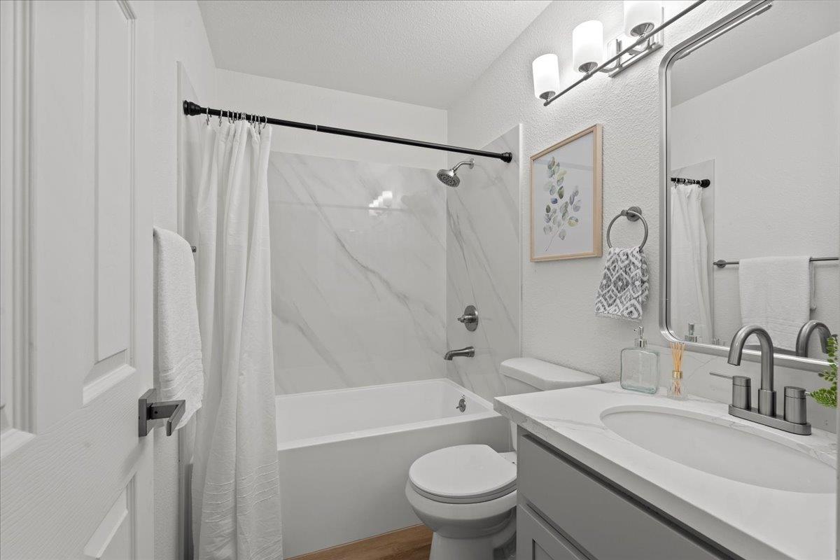 6637 Briartree Way Citrus Heights, CA 95621 - Photo 16 of 23 a bathroom with a granite countertop sink a toilet a mirror a vanity and shower