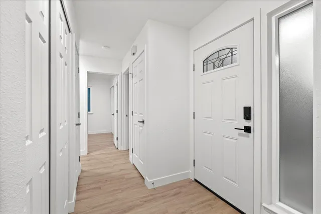 a view of a hallway with wooden floor