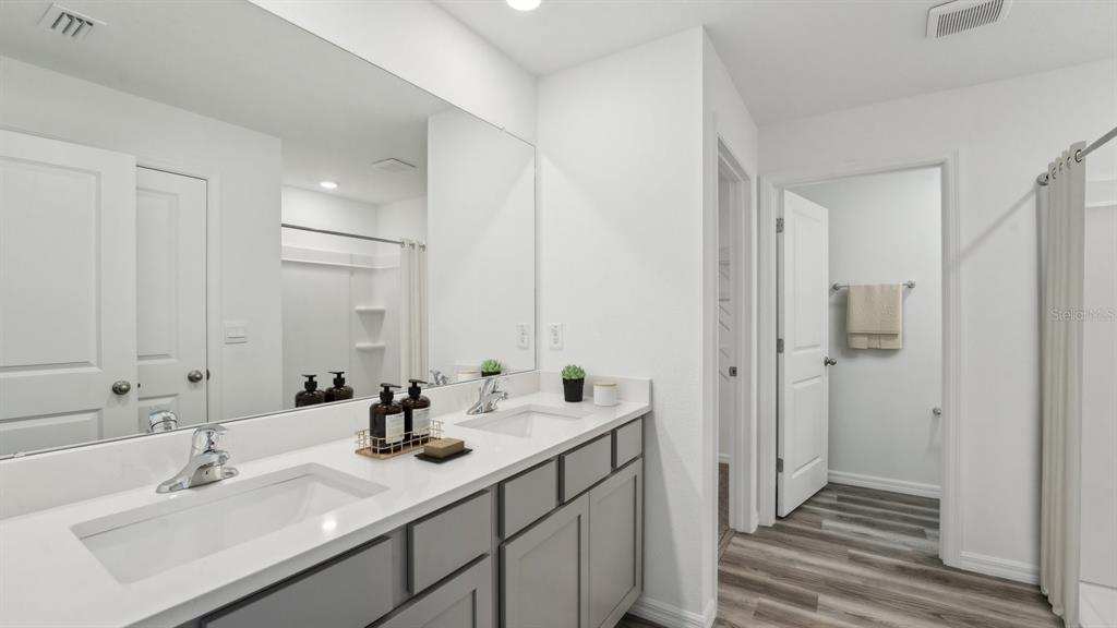 35381 Vly Rdg Road Dade City, FL 33525 - Photo 20 of 22 a bathroom with a sink double vanity and a mirror