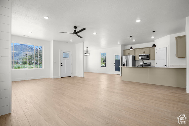 1631 West Century Lane, Unit B Mapleton, UT 84664 - Photo 5 of 33 Unfurnished living room with light wood-type flooring, plenty of natural light, ceiling fan, and recessed lighting