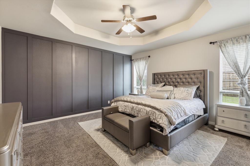 215 Equestrian Road Hickory Creek, TX 75065 - Photo 24 of 36 a spacious bedroom with a bed and a chandelier