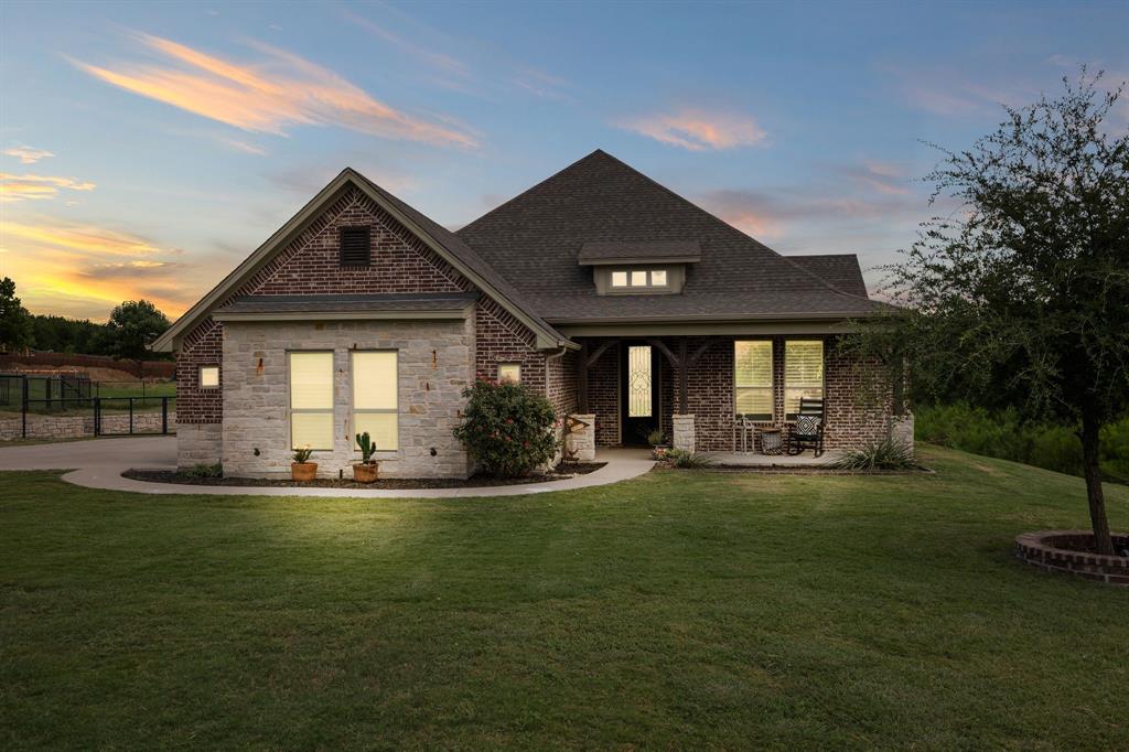 2103 Cash Point Court Granbury, TX 76049 - Photo 1 of 38 a front view of a house with swimming pool having outdoor seating