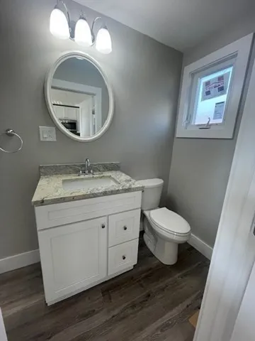 a bathroom with a toilet a sink and a mirror
