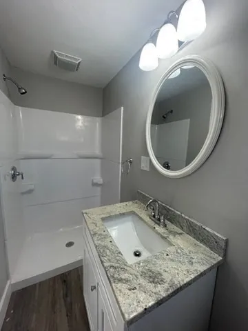 a bathroom with a sink a vanity and a mirror