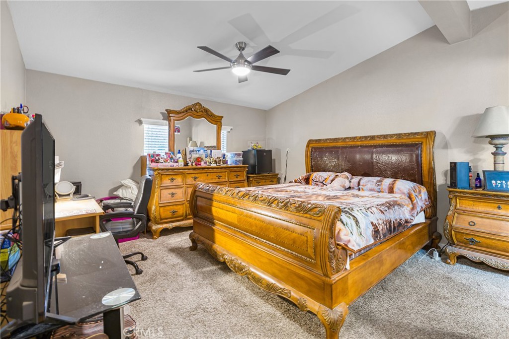 21650 Temescal Canyon Road, Unit 13 Corona, CA 92883 - Photo 12 of 21 a bed room with a bed and a chandelier