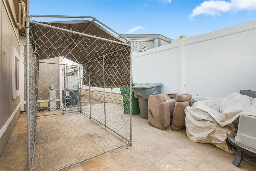 21650 Temescal Canyon Road, Unit 13 Corona, CA 92883 - Photo 17 of 21 a view of a patio with table and chairs and potted plants
