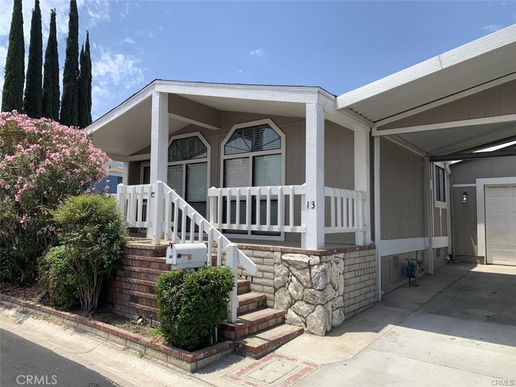 21650 Temescal Canyon Road, Unit 13 Corona, CA 92883 - Photo 2 of 21 front view of a house with a small yard