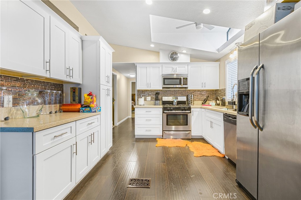 21650 Temescal Canyon Road, Unit 13 Corona, CA 92883 - Photo 6 of 21 a kitchen with stainless steel appliances a refrigerator sink and microwave