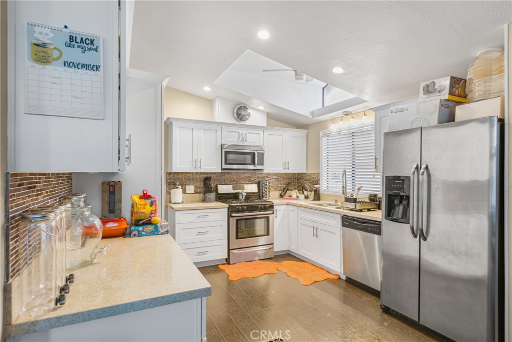 21650 Temescal Canyon Road, Unit 13 Corona, CA 92883 - Photo 7 of 21 a kitchen with stainless steel appliances granite countertop a refrigerator sink and stove