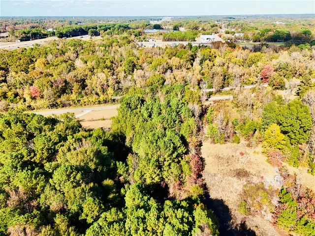 an aerial view of a houses with a lush green hillside