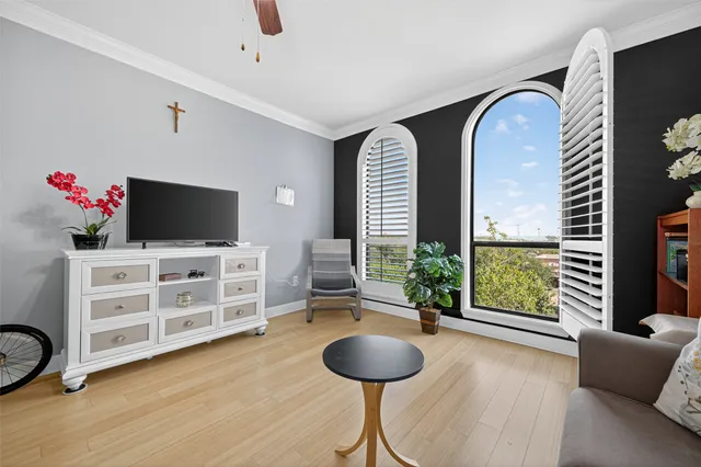 a view of a livingroom with workspace and a window