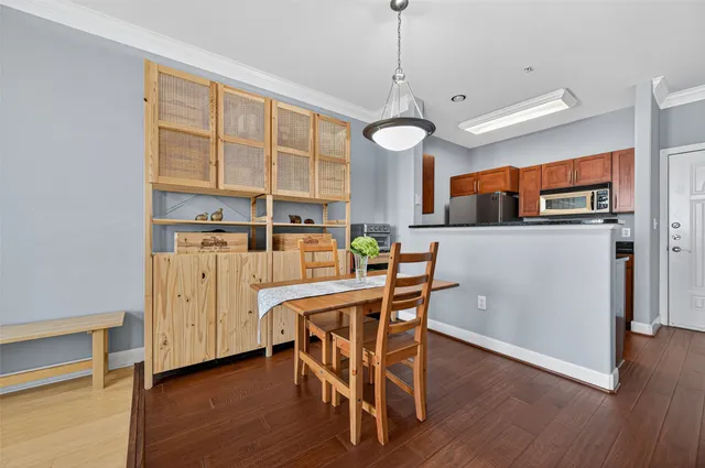 a view of a dining room with furniture and wooden floor