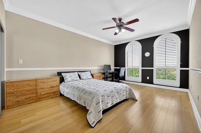 a bedroom with a bed and a large window